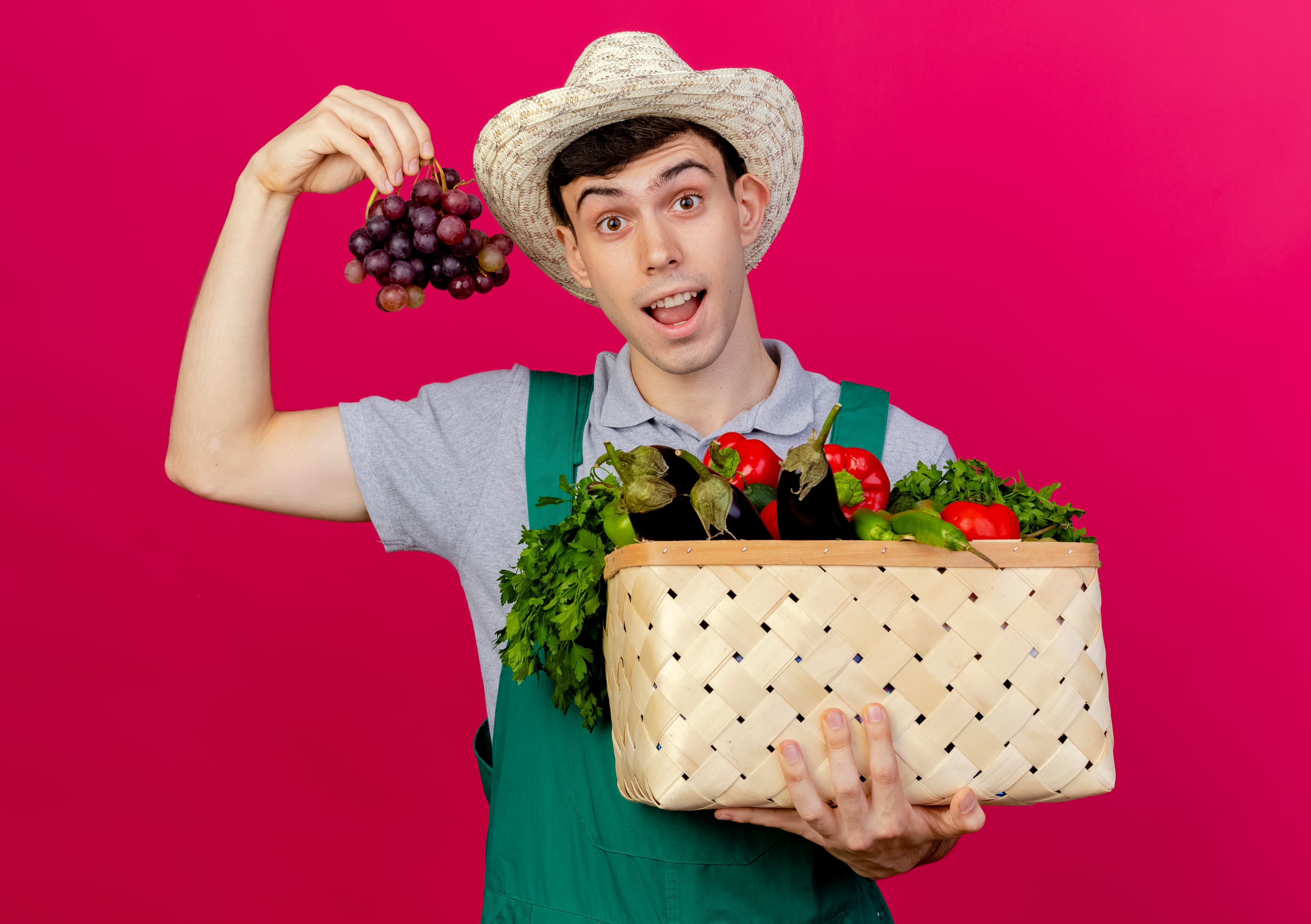 Happy farmer holding a box of fresh vegetables